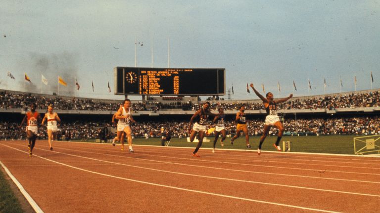 Mexico City, Mexico: Tom Smith of the U.S. winning the final in the 200 meter dash. He ran the last five yards with his arms raised in the air in a victory sign. 1968 Olympics