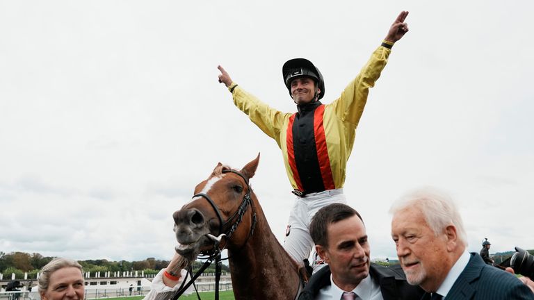 Jockey Rene Piechulek celebrates on Torquator Tasso after winning the Prix de l'Arc de Triomphe