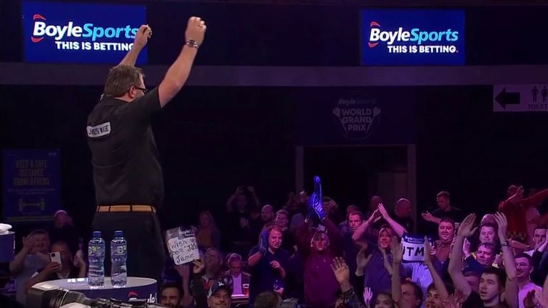 James Wade takes out a 121 checkout on the bullseye to defeat Damon Heta in a thriller at the World Grand Prix.
