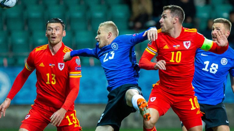 Estonia's Taijo Teniste fights for the ball with Wales' Kieffer Moore