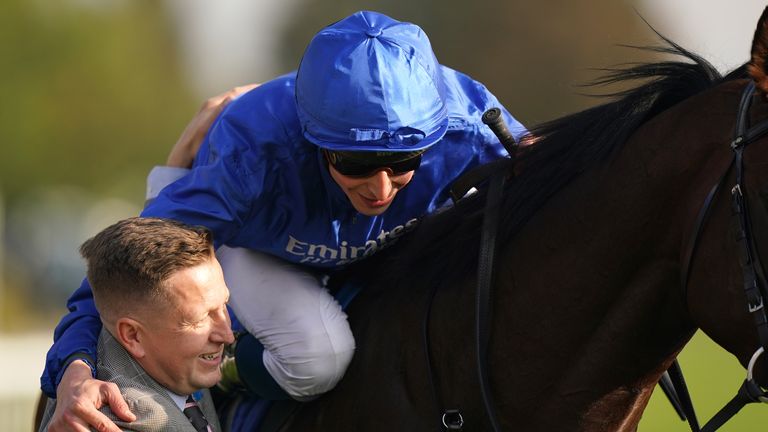 William Buick celebrates with a member of team Charlie Appleby after victory on the Indigenous Trail in Dewhurst Stakes