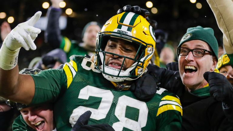 Green Bay Packers' AJ Dillon celebrates with fans after rushing for a touchdown during the second half of an NFL football game against the Seattle Seahawks Sunday, Nov. 14, 2021, in Green Bay, Wis. (AP Photo/Aaron Gash)