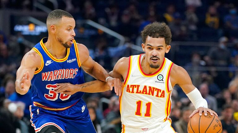 Atlanta Hawks guard Trae Young (11) is defended by Golden State Warriors guard Stephen Curry during the first half of an NBA basketball game in San Francisco, Monday, Nov. 8, 2021. (AP Photo/Jeff Chiu)