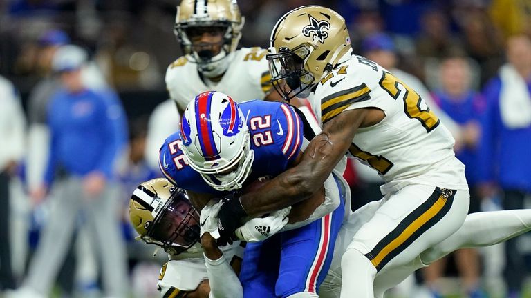 Buffalo Bills running back Matt Breida (22) is stopped by New Orleans Saints safety Malcolm Jenkins (27) and cornerback Marshon Lattimore in the first half of an NFL football game in New Orleans, Thursday, Nov. 25, 2021. (