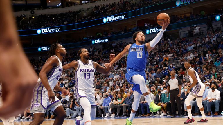 Dallas Mavericks guard Jalen Brunson (13) goes for a layup in front of Sacramento Kings center Tristan Thompson (13) and guard Buddy Hield (24) during the first half of an NBA basketball game in Dallas, Sunday, Oct. 31, 2021. (AP Photo/Michael Ainsworth)