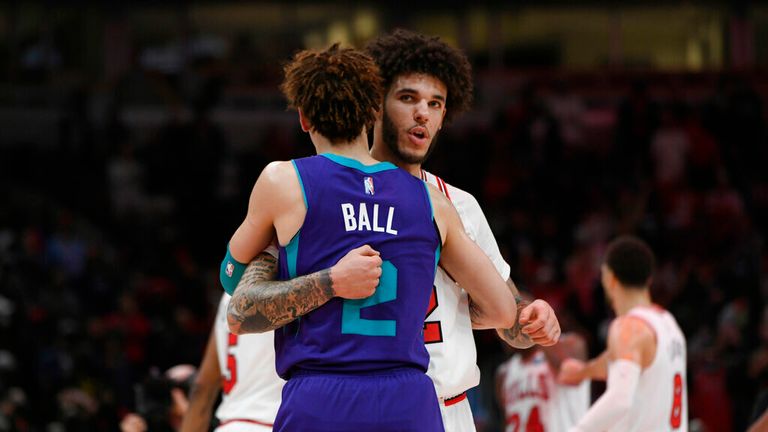 Chicago Bulls guard Lonzo Ball (2) hugs brother Charlotte Hornets guard LaMelo Ball (2) after a NBA basketball game Monday, Nov. 29, 2021 in Chicago. Chicago won 133-119. (AP Photo/Paul Beaty)