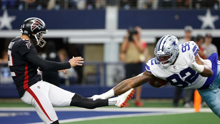Atlanta Falcons punter Dustin Colquitt has his punt blocked by Dallas Cowboys defensive end Dorance Armstrong (92) in the first first half of an NFL football game in Arlington