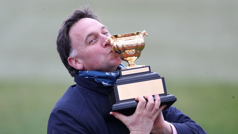 Henry De Bromhead kisses the Cheltenham Gold Cup trophy after Minella Indo&#39;s success
