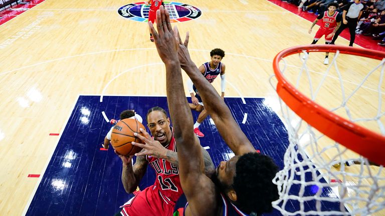 Chicago Bulls forward DeMar DeRozan  goes up for a shot against Philadelphia 76ers center Joel Embiid