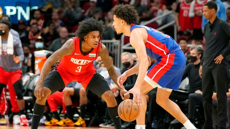Detroit Pistons guard Cade Cunningham, right, dribbles as Houston Rockets guard Jalen Green defends during the second half of an NBA basketball game, Wednesday, Nov. 10, 2021, in Houston. (AP Photo/Eric Christian Smith)