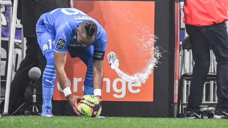 Marseille&#39;s Dimitri Payet was hit by a bottle of water thrown from the stands during the Ligue 1 match against Lyon