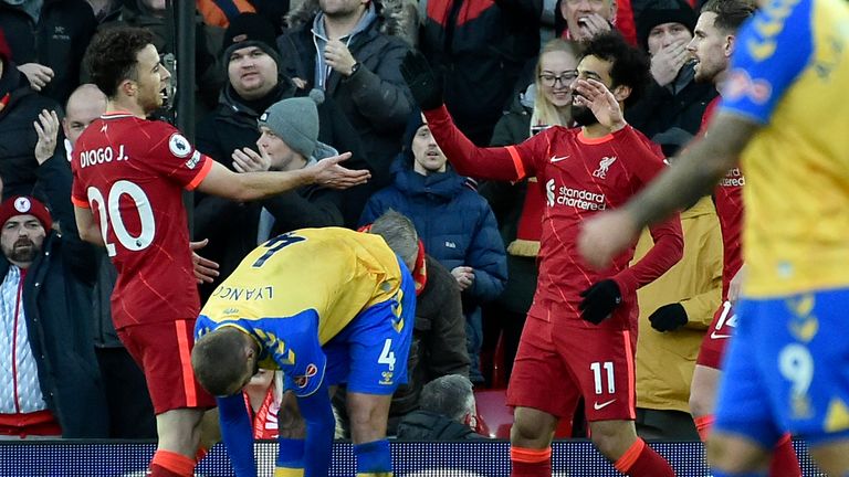 Diogo Jota celebrates scoring his second goal with Mohamed Salah and Jordan Henderson AP