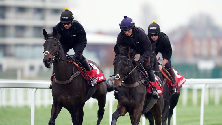 Enrilo (front, right) gallops with rider Harry Cobden at Newbury