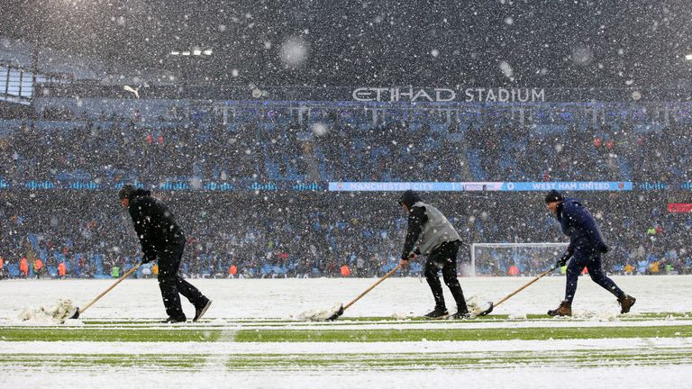 The grounds staff at the Etihad had to clear the entire pitch of snow at half-time