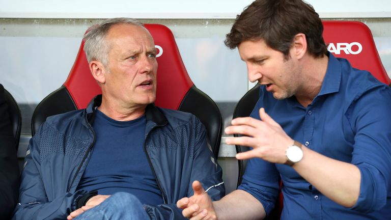 Freiburg head coach Christian Streich in conversation with sporting CEO Jochen Saier
