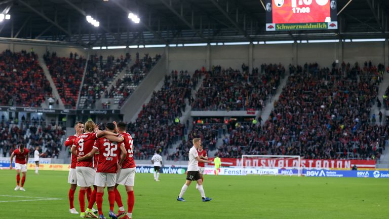 Freiburg players celebrate after scoring against St Pauli in a friendly to mark the opening of their new stadium