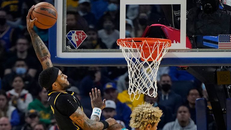 Golden State Warriors guard Gary Payton II, dunks against Charlotte Hornets guard Kelly Oubre Jr. 