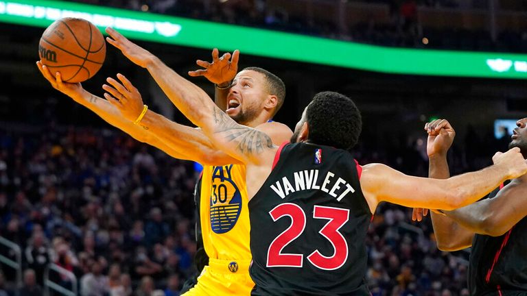 Golden State Warriors guard Stephen Curry, left, shoots against Toronto Raptors guard Fred VanVleet (23) during the second half of an NBA basketball game in San Francisco, Sunday, Nov. 21, 2021. (AP Photo/Jeff Chiu)