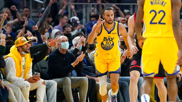 Golden State Warriors guard Stephen Curry (30) reacts after shooting a 3-point basket against the Toronto Raptors during the first half of an NBA basketball game in San Francisco, Sunday, Nov. 21, 2021. (AP Photo/Jeff Chiu)