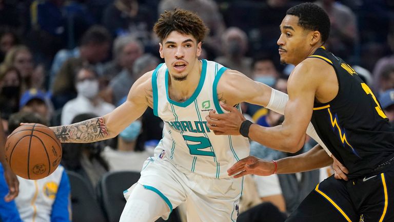 Charlotte Hornets guard LaMelo Ball drives to the basket against Golden State Warriors guard Jordan Poole