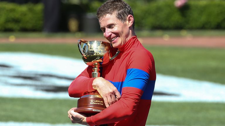Jockey James McDonald hugs the Melbourne Cup trophy after riding Verry Elleegant to victory (AP)