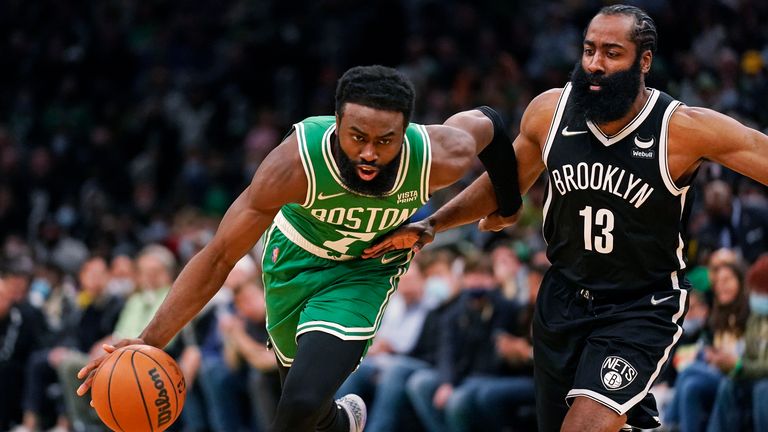 Boston Celtics guard Jaylen Brown drives past Brooklyn Nets guard James Harden