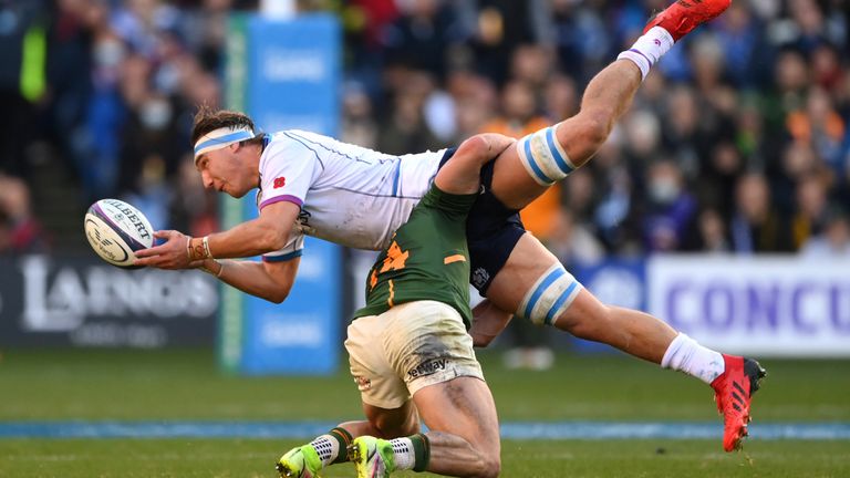 Jamie Ritchie of Scotland makes a pass as he is tackled by Jesse Kriel 