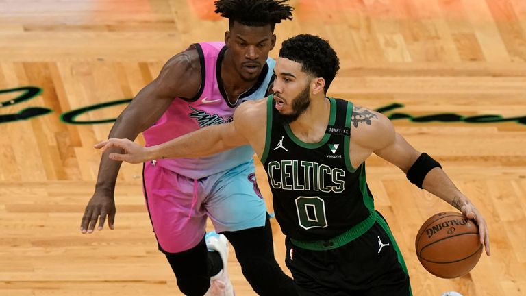 Jayson Tatum is chased on the dribble by Jimmy Butler