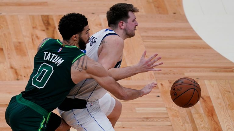 Jayson Tatum and Luka Doncic jostle for possession