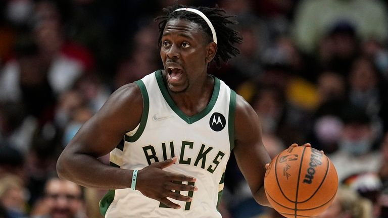 Milwaukee Bucks guard Jrue Holiday brings the ball up court against the Denver Nuggets