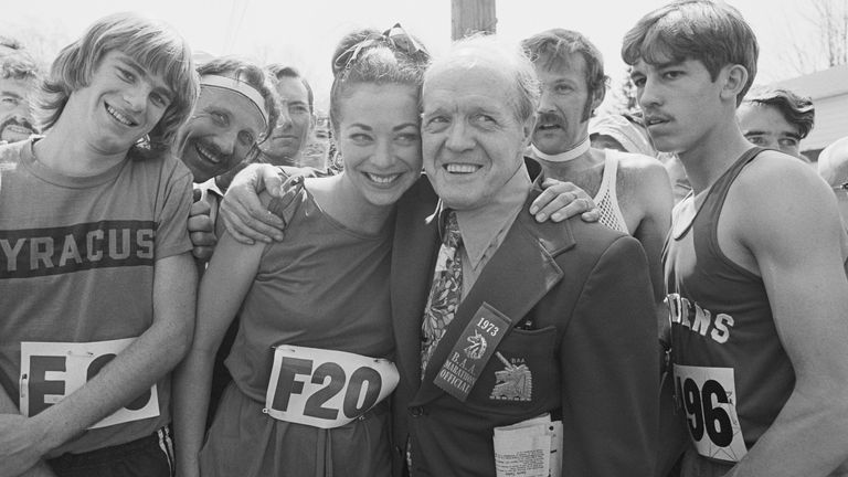 Jock Semple (R) B.A.A., Boston Marathon official, who for years was against women running in the famous Boston Marathon, poses with pretty Katherine Switzer (L) a marathoner from the Central Park A.C., prior to start of the 77th annual race in 1973. The 26-mile 385-yd., event was won by Jon Anderson of the Oregon T.C.