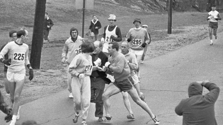  The rule that no women shall run in the Boston Athletic Association (BAA) Marathon is being put to a very real test in this photo. Trainer Jack Semple (in street clothes) enters the field of runners to try to pull Kathy Switzer (261) out of the race. Male runners move in to form protective curtain around the female track hopeful, until the protesting trainer is finally wedged out of the race, and the lady is allowed to finish the marathon.