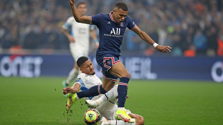 Marseille...s William Saliba tackles PSG...s Kylian Mbappe during the French League One soccer match between Marseille and Paris Saint-Germain in Marseille, France, Sunday, Oct. 24, 2021. (AP Photo/Daniel Cole)