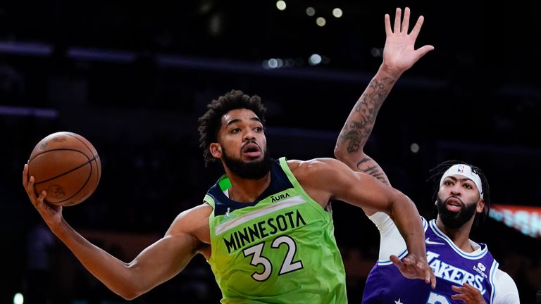 Minnesota Timberwolves&#39; Karl-Anthony Towns passes the ball as Los Angeles Lakers&#39; Anthony Davis defends