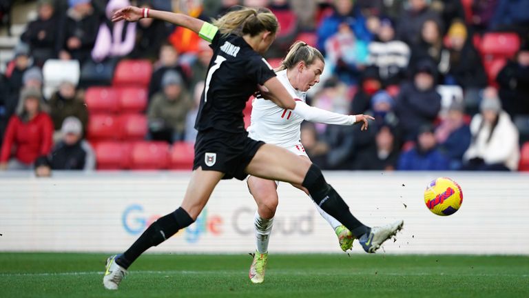 Lauren Hemp (right) has a shot on goal