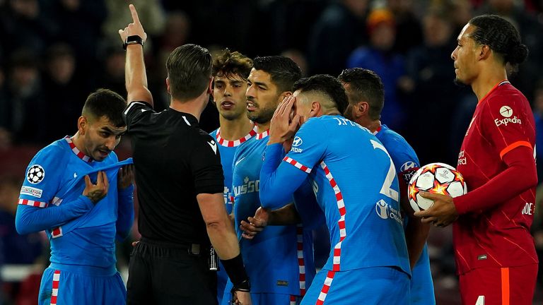 Atletico Madrid players protest to referee Danny Makkelie after showing Atletico Madrid's Augusto Felipe (not pictured) a straight red