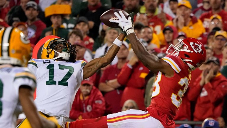 Kansas City Chiefs cornerback L&#39;Jarius Sneed, right, intercepts a pass intended for Green Bay Packers wide receiver Davante Adams (17) as Packers wide receiver Marquez Valdes-Scantling (83) watches during the second half of an NFL football game 