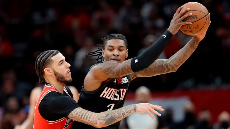 Chicago Bulls guard Lonzo Ball reaches in as Houston Rockets guard Kevin Porter Jr. protects the ball