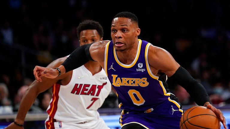 Los Angeles Lakers guard Russell Westbrook (0) drives to the hoop against Miami Heat guard Kyle Lowry (7) during the first half of an NBA basketball game in Los Angeles, Wednesday, Nov. 10, 2021. (AP Photo/Ashley Landis)