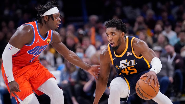 Utah Jazz guard Donovan Mitchell is defended by Oklahoma City Thunder forward Luguentz Dort