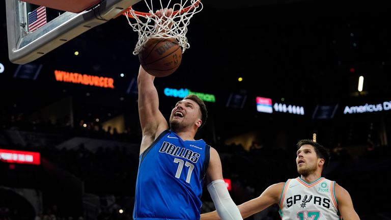 Dallas Mavericks guard Luka Doncic scores past San Antonio Spurs forward Doug McDermott
