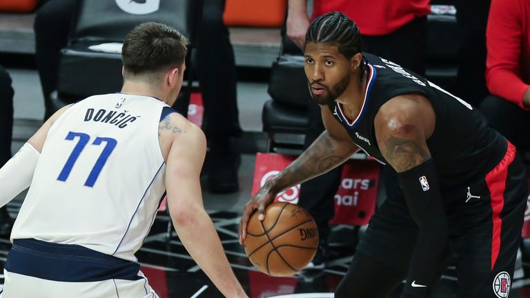 Los Angeles Clippers guard Paul George guarded by Dallas Mavericks guard Luka Doncic