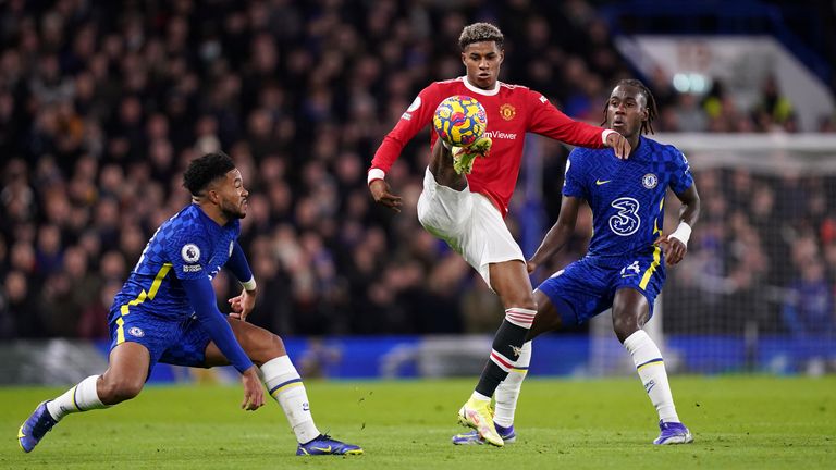 Manchester United's Marcus Rashford in action with Chelsea's Reece James (left) and Trevoh Chalobah