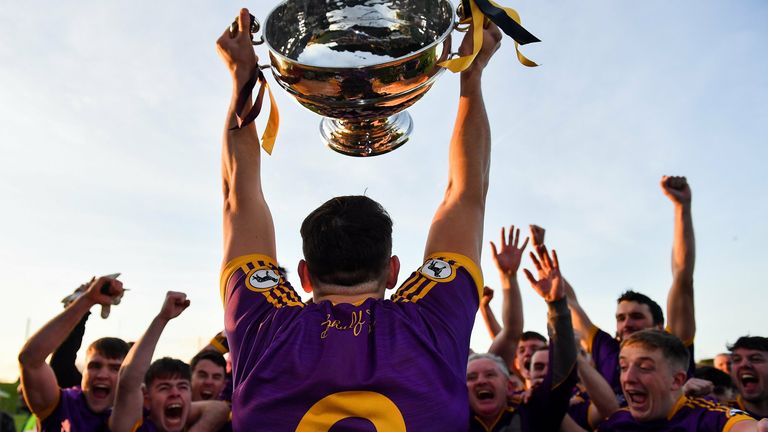 7 November 2021; Wolfe Tones captain Shane Glynn lifts the trophy in front of team-mates after their side's victory in the Meath County Senior Club Football Championship Final match between St Peter's Dunboyne and Wolfe Tones at P..irc Tailteann in Navan, Meath. Photo by Seb Daly/Sportsfile