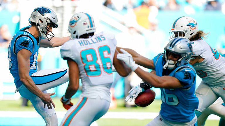 Miami Dolphins outside linebacker  (45), right, blocks a punt by Carolina Panthers punter Lachlan Edwards (10) during the first half of an NFL football game, Sunday, Nov. 28, 2021, in Miami Gardens, Fla. The play lead to a touchdown by Miami Dolphins cornerback Justin Coleman. (AP Photo/Wilfredo Lee)