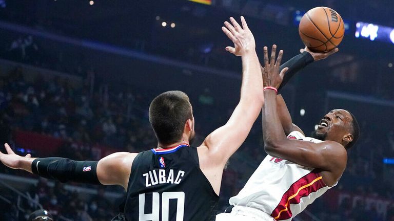 Miami Heat center Bam Adebayo, right, shoots over Los Angeles Clippers center Ivica Zubac (40) during the first half of an NBA basketball game Thursday, Nov. 11, 2021, in Los Angeles. (AP Photo/Marcio Jose Sanchez)