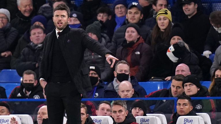 Manchester United caretaker manager Michael Carrick on the touchline as Cristiano Ronaldo looks on from the bench