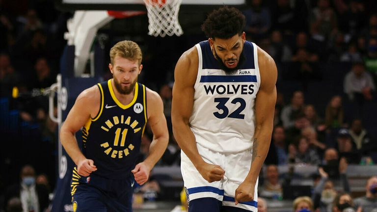 Minnesota Timberwolves center Karl-Anthony Towns (32) reacts after scoring a three-point basket during the second half of an NBA basketball game against the Indiana Pacers, Monday, Nov. 29, 2021, in Minneapolis. (AP Photo/Stacy Bengs)