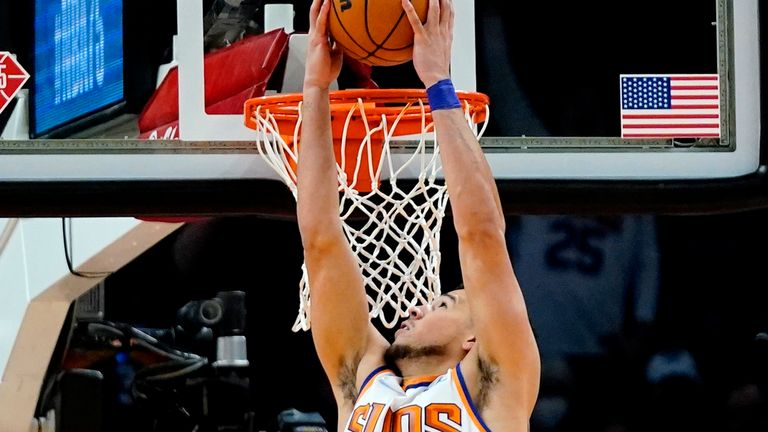 Phoenix Suns guard Devin Booker dunks against the New Orleans Pelicans during the second half of an NBA basketball game Tuesday, Nov. 2, 2021, in Phoenix. The Suns won 112-100. (