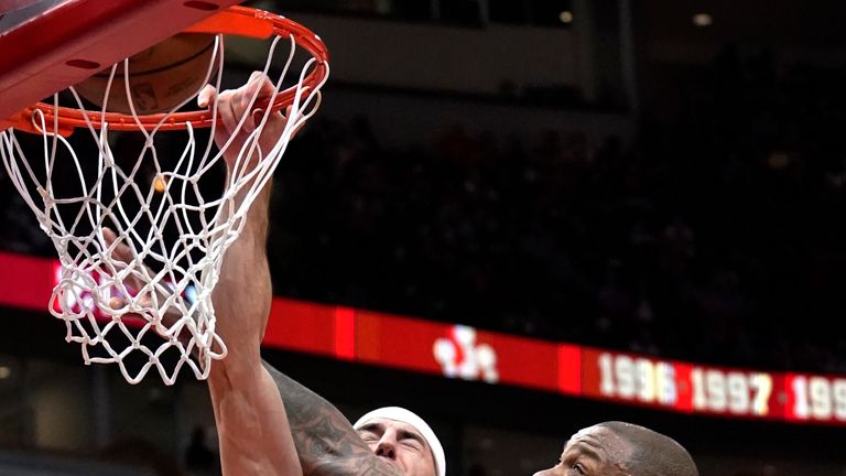 Chicago Bulls guard Alex Caruso, left, dunks against Miami Heat forward PJ Tucker during the first half of    an NBA basketball game in    Chicago, Saturday, November 27, 2021. (AP Photo/Nam Y. Huh)


